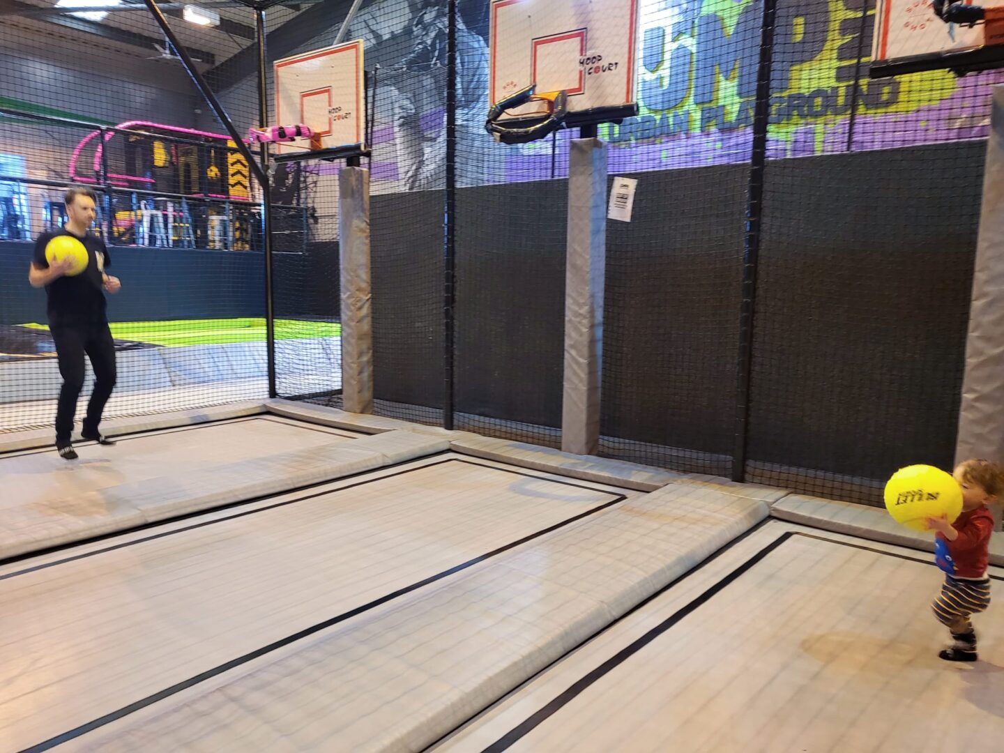 Burning energy by trampolining with a toddler at Jump Inc Bicester - basketball court